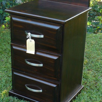 simple yet elegant solid wood pedestal, stained dark with three drawers