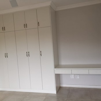 built in dressing room cupboards with table and drawers