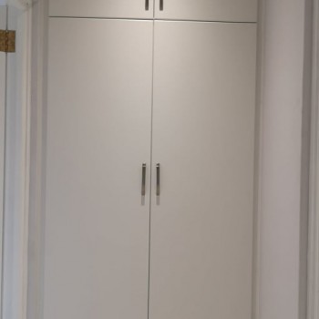 simple built-in linen cupboard in white