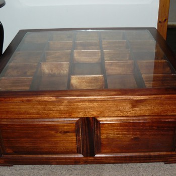 Coffee table with glass top and display boxes, stained Saligna