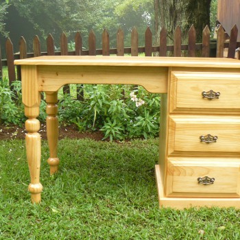 Cyrpess desk with three large drawers and ornate handles