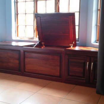 custom designed fitted storage cupboards in dark wood