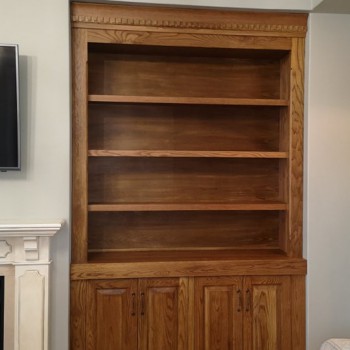 Custom, handmade fitted bookshelves in solid Oak, with vintage crown detail