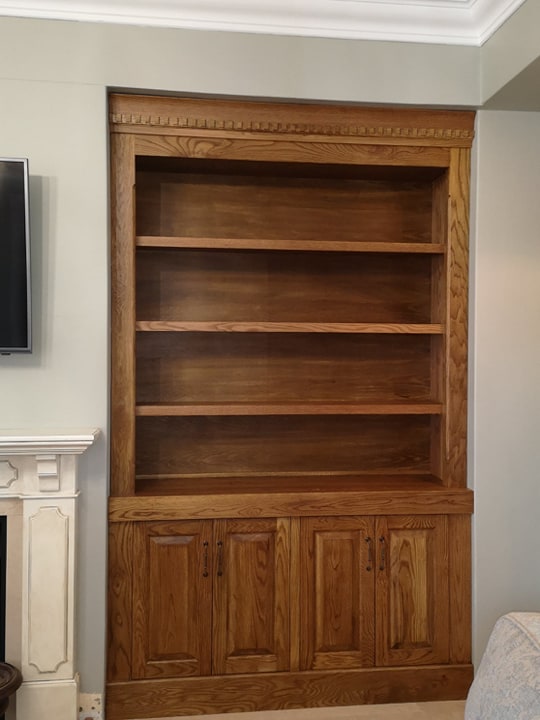 Custom, handmade fitted bookshelves in solid Oak, with vintage crown detail